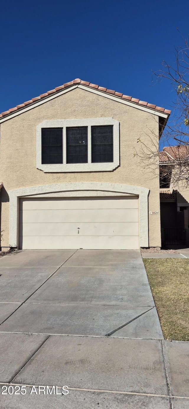 view of front of property with stucco siding and a garage