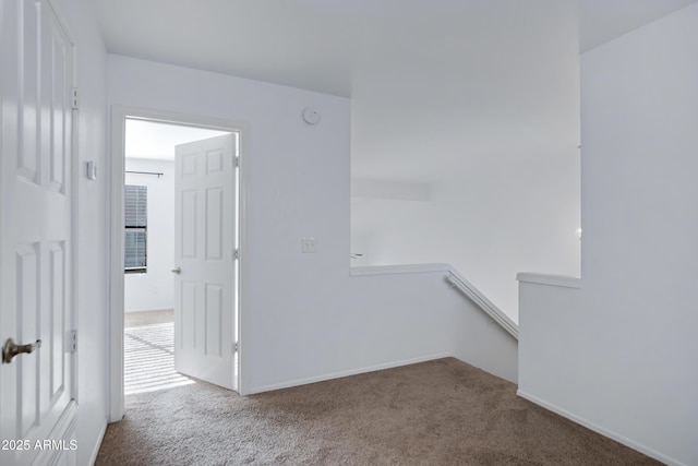 carpeted spare room with baseboards