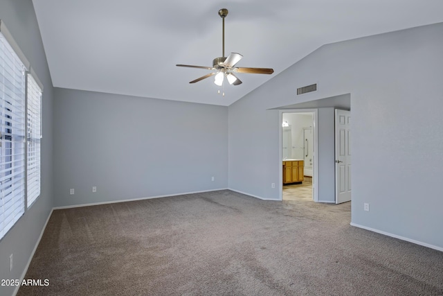 unfurnished room featuring visible vents, baseboards, vaulted ceiling, light carpet, and a ceiling fan