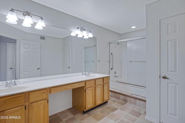 full bathroom with a sink, visible vents, bath / shower combo with glass door, and double vanity