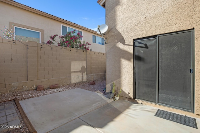 view of patio featuring visible vents and fence