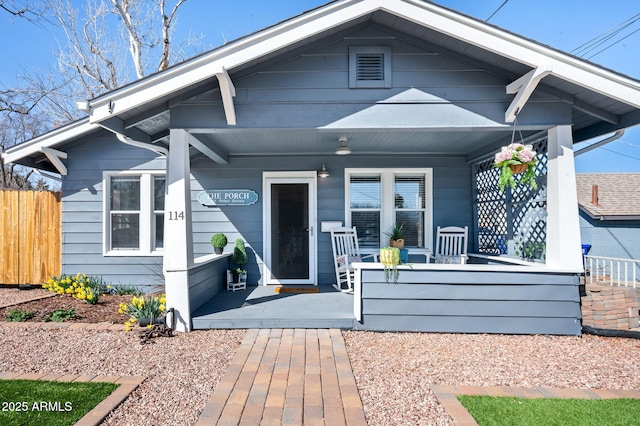 view of front facade with a porch and fence