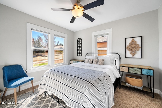 bedroom with a ceiling fan, baseboards, and carpet floors