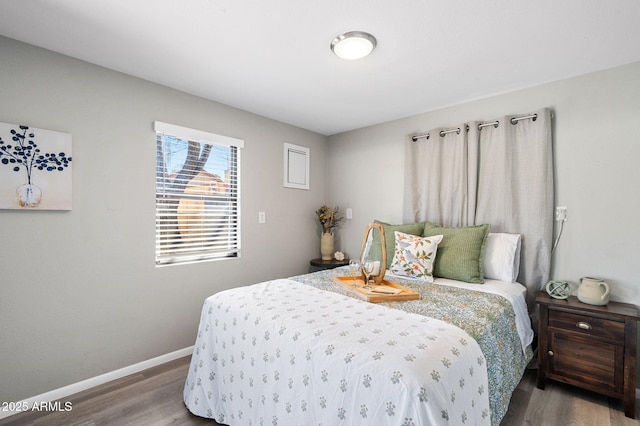 bedroom featuring baseboards and wood finished floors