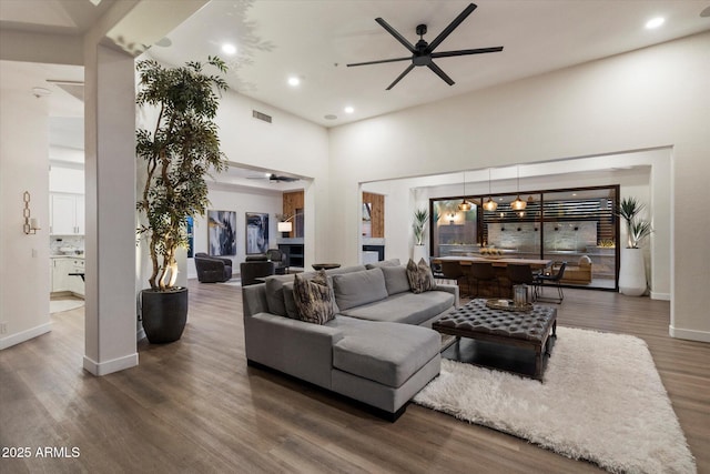 33667 N 71st Way, Scottsdale, AZ 85266 - living room with a ceiling fan, recessed lighting, wood finished floors, baseboards, and a towering ceiling
