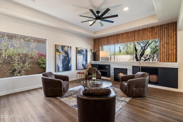 33667 N 71st Way, Scottsdale, AZ 85266 - living room with a tray ceiling, a fireplace, baseboards, wood finished floors, and recessed lighting