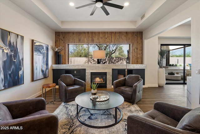 33667 N 71st Way, Scottsdale, AZ 85266 - living room featuring a ceiling fan, baseboards, a raised ceiling, a brick fireplace, and wood finished floors