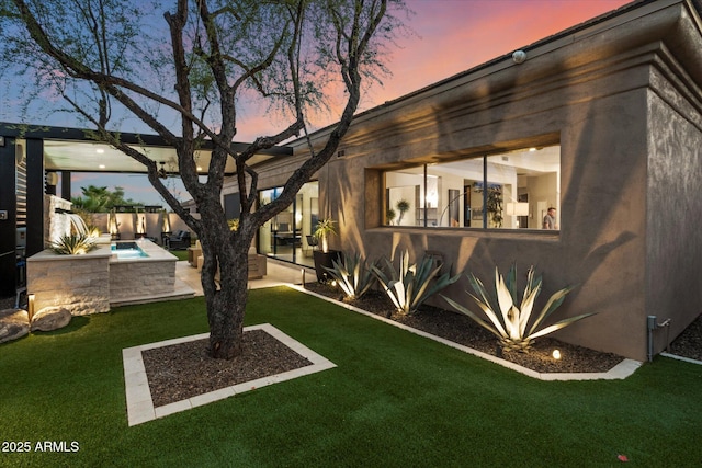 33667 N 71st Way, Scottsdale, AZ 85266 - back of house at dusk featuring a patio and stucco siding