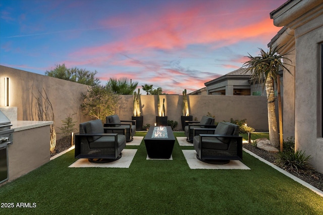33667 N 71st Way, Scottsdale, AZ 85266 - yard at dusk with an outdoor living space with a fire pit and a patio area