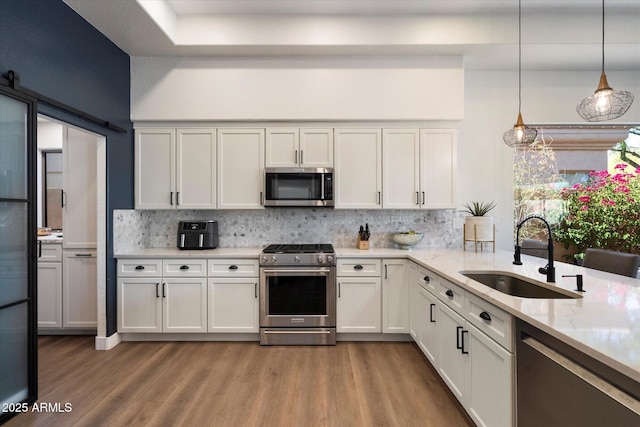 33667 N 71st Way, Scottsdale, AZ 85266 - kitchen with appliances with stainless steel finishes, a sink, wood finished floors, and decorative backsplash