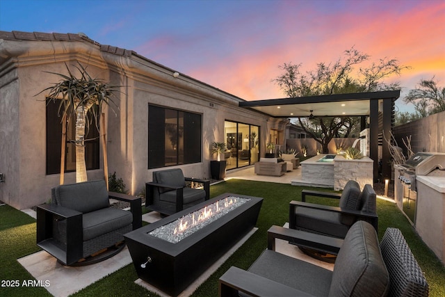 33667 N 71st Way, Scottsdale, AZ 85266 - patio terrace at dusk featuring an outdoor living space with a fire pit, a patio area, and area for grilling