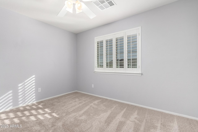 carpeted spare room with ceiling fan