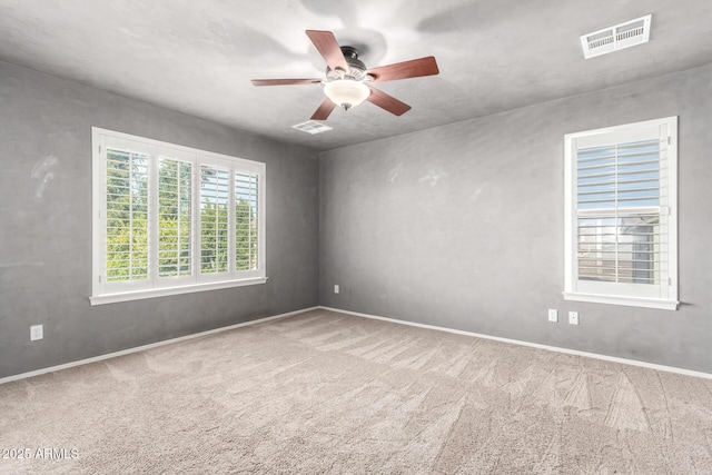 spare room with carpet and ceiling fan