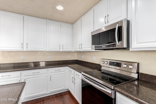 kitchen featuring white cabinetry, dark hardwood / wood-style floors, and appliances with stainless steel finishes