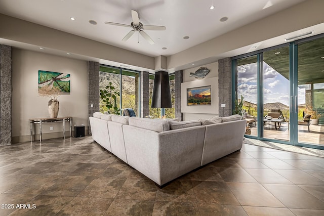 living room with a ceiling fan, visible vents, and recessed lighting
