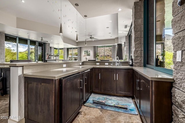 kitchen featuring light countertops, dark brown cabinets, ceiling fan, and recessed lighting