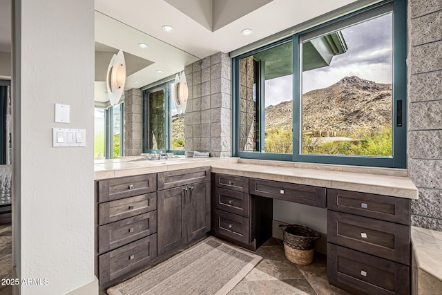 bathroom with stone finish floor, vanity, a mountain view, and recessed lighting