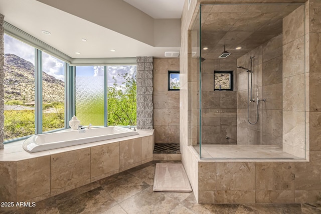 bathroom featuring a garden tub, a wealth of natural light, and tiled shower