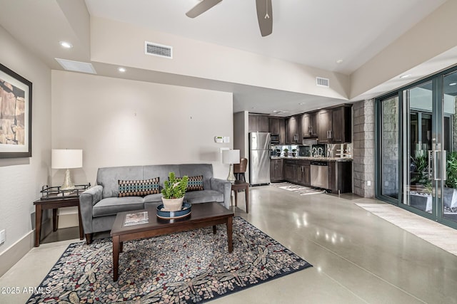 living room featuring concrete floors, visible vents, a ceiling fan, and recessed lighting
