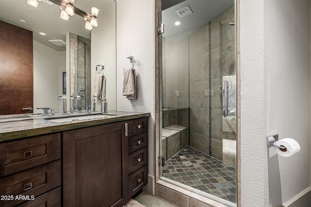 bathroom with recessed lighting, visible vents, vanity, and a stall shower