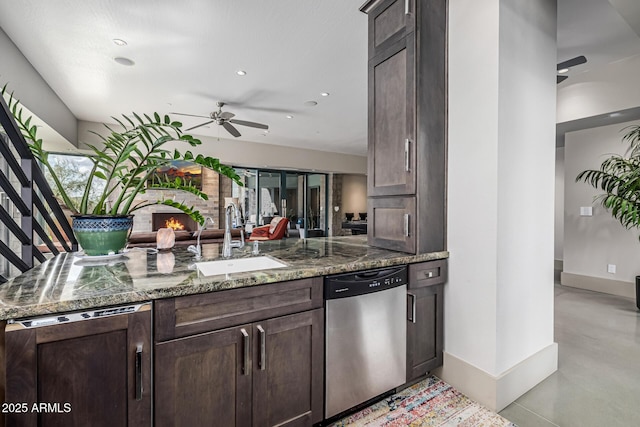 kitchen featuring paneled dishwasher, stainless steel dishwasher, a sink, dark brown cabinetry, and ceiling fan