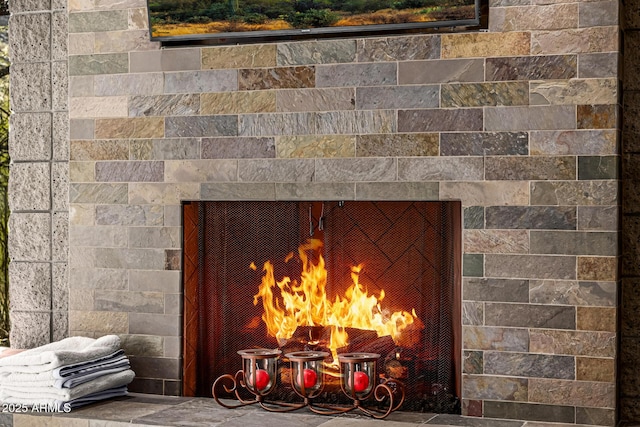 exterior details with a warm lit fireplace and a notable chandelier