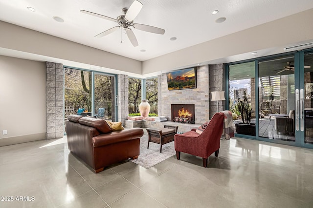 living room with ceiling fan, a lit fireplace, and recessed lighting