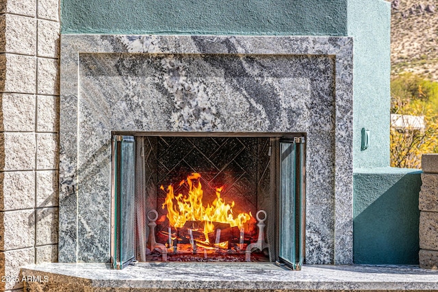 exterior details featuring a high end fireplace