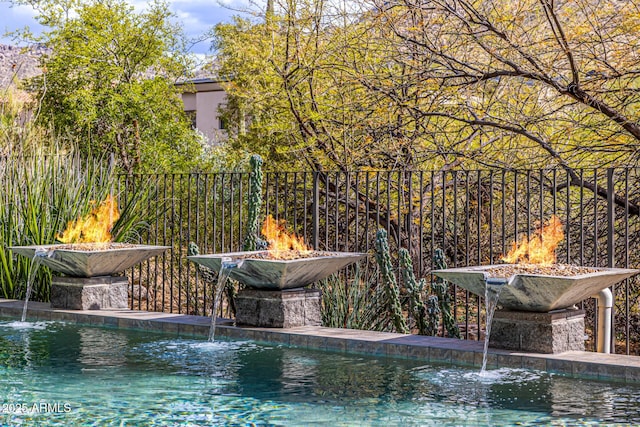 view of pool featuring a fire pit
