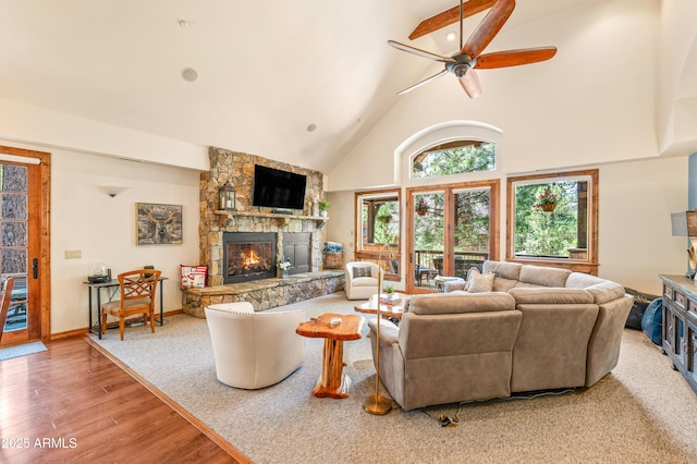 1697 E Solitude Ct Unit 22, Flagstaff, AZ 86005 - living room featuring a stone fireplace, a ceiling fan, wood finished floors, and high vaulted ceiling