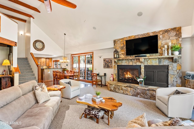 1697 E Solitude Ct Unit 22, Flagstaff, AZ 86005 - carpeted living room with a fireplace, stairs, high vaulted ceiling, beam ceiling, and a chandelier