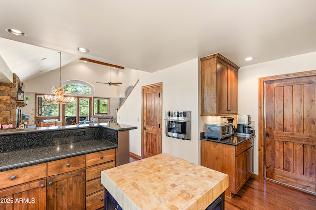 1697 E Solitude Ct Unit 22, Flagstaff, AZ 86005 - kitchen with dark wood-style flooring, lofted ceiling, a chandelier, wood counters, and oven