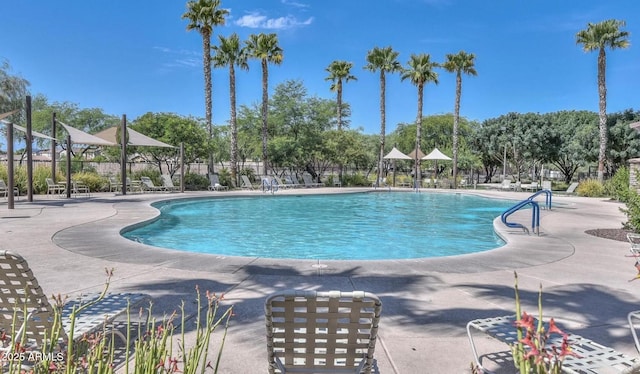 pool featuring fence and a patio