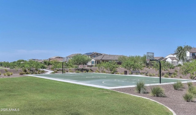 view of basketball court featuring community basketball court, a lawn, and a residential view