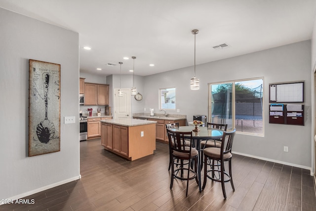 dining area with dark wood-type flooring and sink