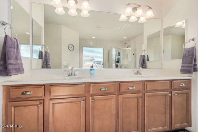 bathroom featuring vanity and a shower with shower door