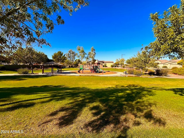 view of property's community featuring a gazebo, a lawn, and a playground