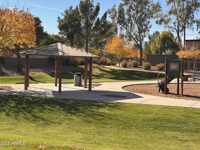 view of community featuring a gazebo, a playground, and a lawn