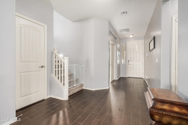 corridor with dark hardwood / wood-style flooring