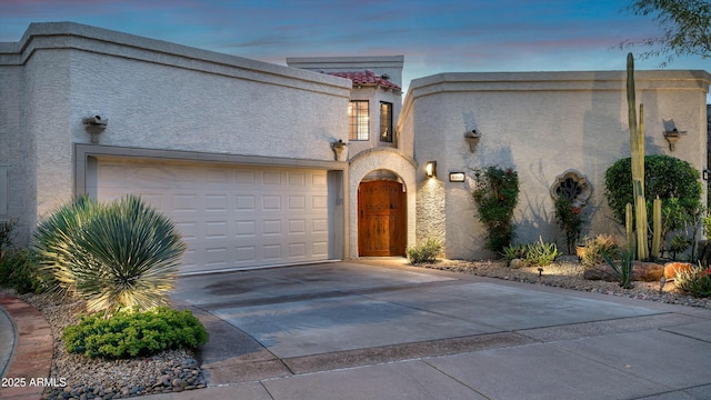 view of front of home with stucco siding and driveway