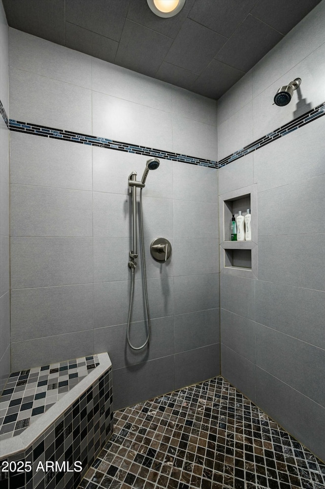 full bath featuring tiled shower