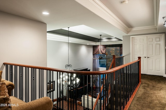 hall featuring crown molding, a tray ceiling, an upstairs landing, carpet flooring, and recessed lighting