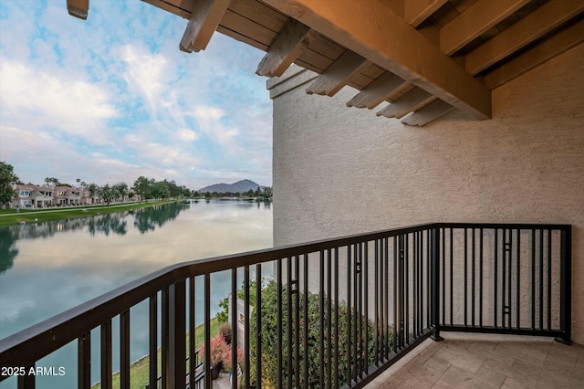 balcony featuring a water and mountain view