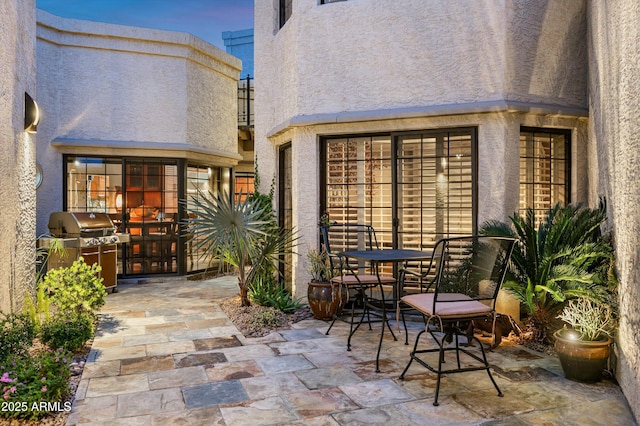 view of patio with outdoor dining area and grilling area