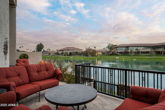 exterior space featuring an outdoor living space, a water view, and a balcony