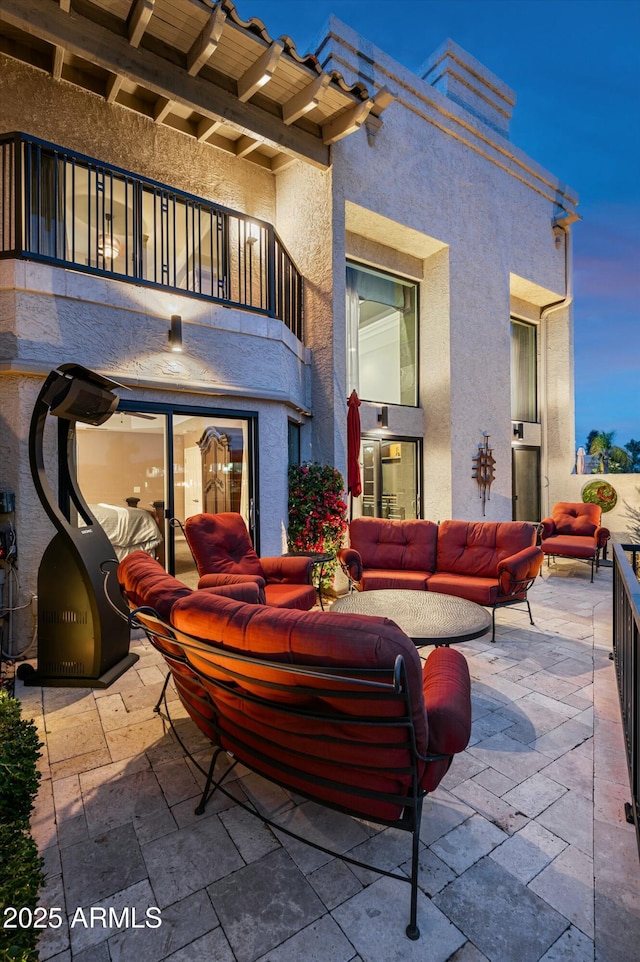 view of patio with outdoor lounge area and a balcony