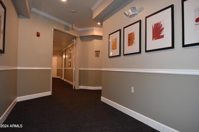 corridor featuring ornamental molding and dark carpet