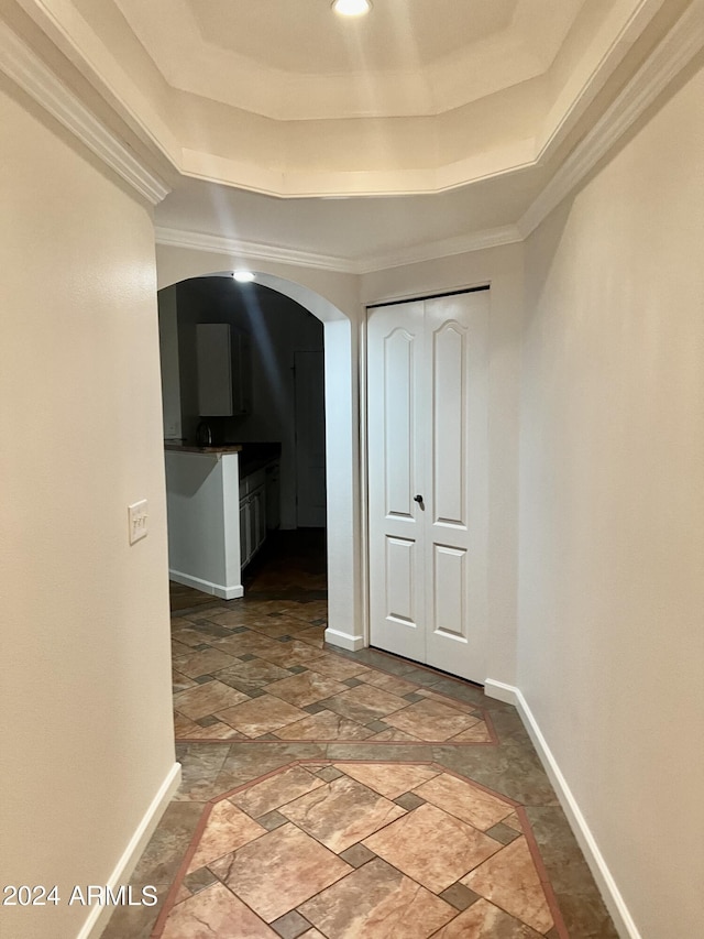 hall featuring a tray ceiling