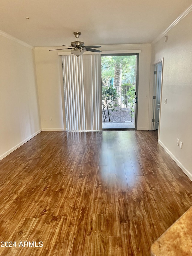 empty room featuring ornamental molding, dark hardwood / wood-style floors, and ceiling fan