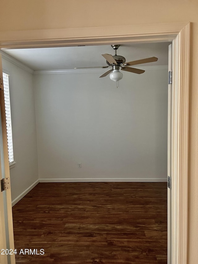 spare room featuring crown molding, dark hardwood / wood-style floors, and ceiling fan